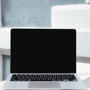 Showcase of a sleek laptop with a blank screen against a minimalist modern backdrop.